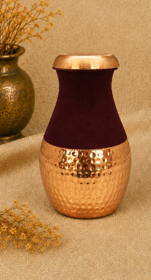 Hammered pure copper jar on a beige cloth